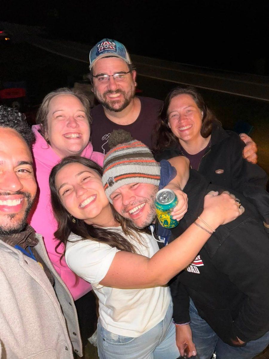 Friends hugging at the night campfire